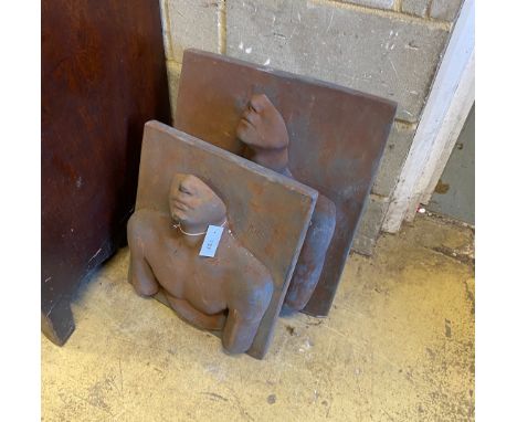 A pair of cast stone abstract portrait relief wall plaques, initialled M J E, larger width 48cm, height 56cm