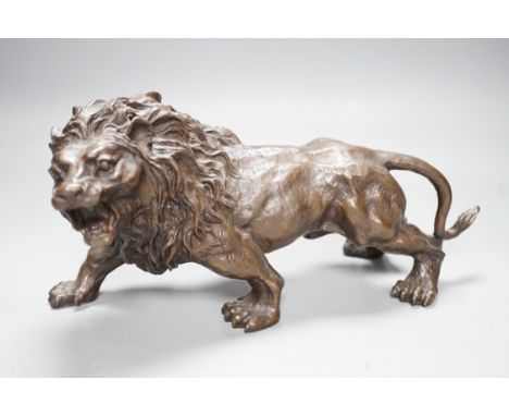 A 20th century bronze figure of a lion, 30cm long