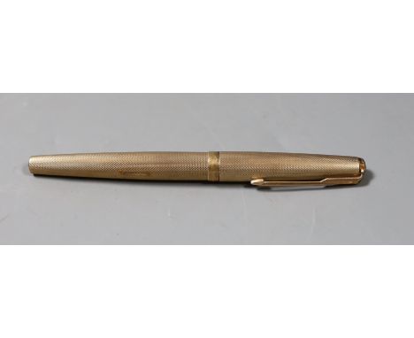 A 1970's engine turned 9ct gold cased Parker fountain pen. 13cm long