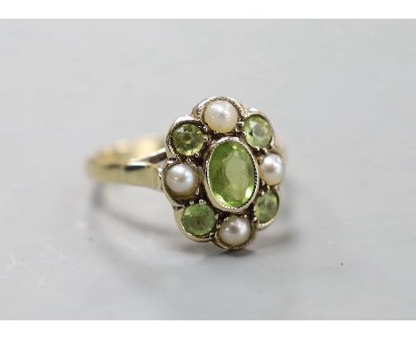 An early 20th century yellow metal, peridot and split pearl cluster set dress ring, size N, gross weight 3 grams.
