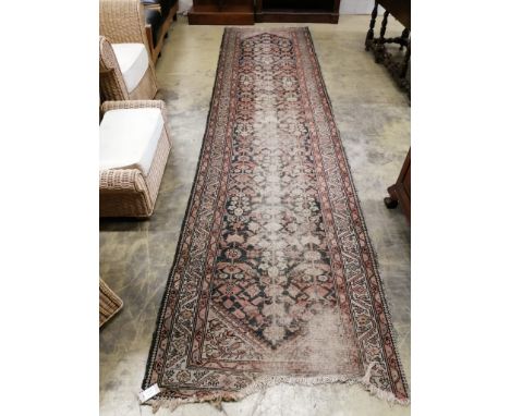 An antique Malayer red ground runner, approx. 260 x 99cm