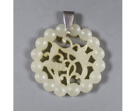 A Chinese carved circular jade pendant. 5.5cm diameter