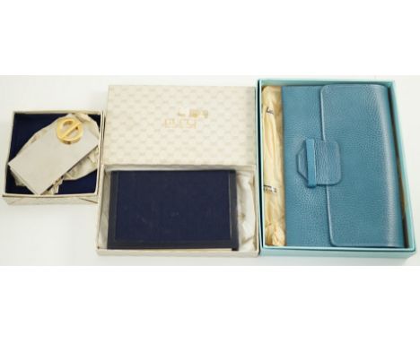 A Gucci blue leather address book, a Smythson leather travel wallet and a Christian Dior desk clip, all boxed.