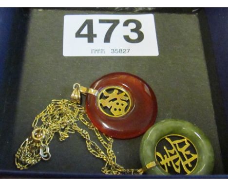 A jade pendant with mounts marked 18k, a chain marked 18kt and another similar pendant marked 18k