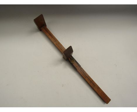 A wood and brass vintage foot measure 
