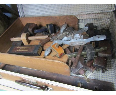 A vintage suitcase contianing sharpening stones, scribes etc 