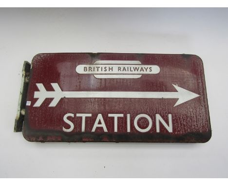 A B.R(M) double sided wall mounted station sign with arrow pointing