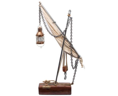 A nautical themed lamp: in the form of a mast and sail with copper ship's lantern suspended from the boom by a chain, with bl