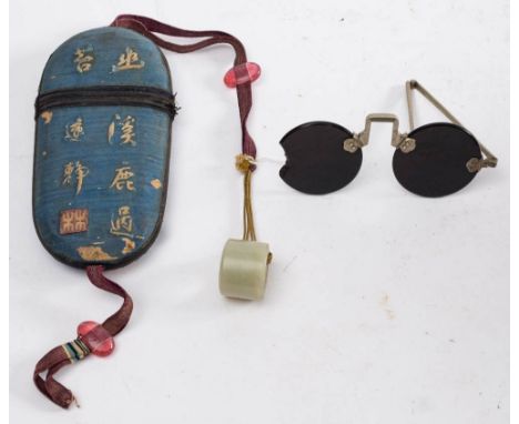 A pair of 19th century Chinese sunglasses in embroidered case:, the circular smoke quartz lenses with folding metal arms (dam