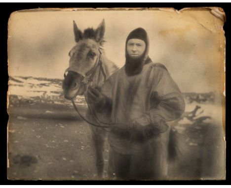 A large photogravure print of F E Davies: in seal skins with an expedition mule, 40cm x 50.2cm. (edges worn).