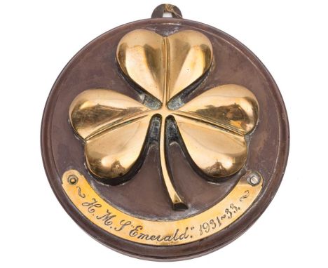 A brass tompion for the Emerald-class light cruiser HMS Emerald (D66):  with three leaf clover over a plaque inscribed 'HMS E