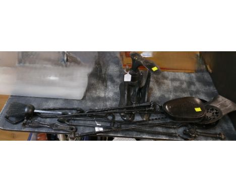 Collection of black painted fireside accessories, shoe lasts etc