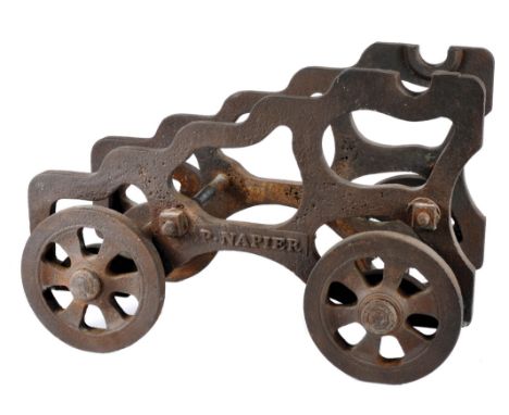 A cast iron carriage for a signalling cannon, stepped openwork sides supported on four spoked wheels, makers name 'P NAPIER',