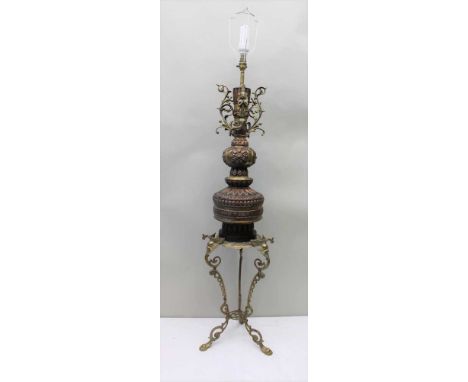 A FAR EASTERN MIXED METAL LAMP with figural top, on beaded flower head pommel, the base having a copper lappet top, on a circ