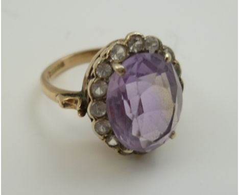 AN AMETHYST DRESS RING, having facet cut oval stone, in a 9ct gold setting, ring size "N" 