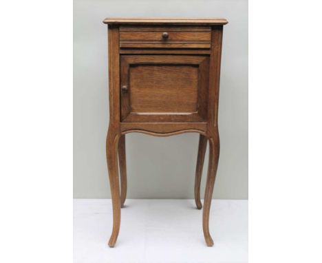 A FRENCH OAK BEDSIDE CUPBOARD, with marble top, fitted drawer and ceramic lined cupboard, raised on cabriole supports, 41cm w