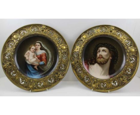 A PAIR OF LATE 19TH CENTURY CONTINENTAL HAND PAINTED PORCELAIN CHARGERS, possibly Vienna (unmarked) one depicts the Madonna a