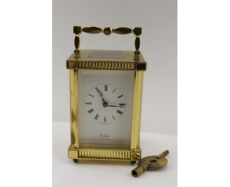 A 20TH CENTURY ENGLISH CARRIAGE CLOCK, the brass frame with folding carrying handle, five bevelled glass panels, white face w