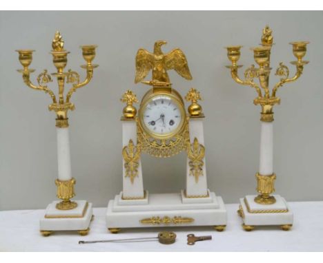A FRENCH EMPIRE DESIGN CLOCK GARNITURE, comprising white marble and gilt metal mounted clock, with eagle mount, having white 