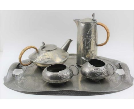 AN ARTS AND CRAFTS TUDRIC PEWTER FIVE PIECE TEA SET, designed by Archibald Knox, comprising; a two-handled tea tray, squat fo