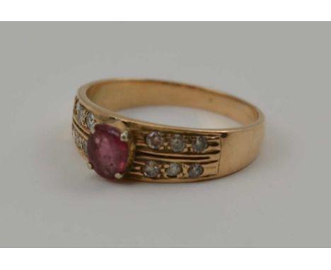 A 14CT GOLD LADY'S DRESS RING, set with central oval cut ruby, flanked by six diamonds to either shoulder, ring size; "P" 