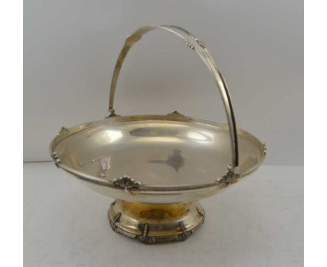 WALKER AND HALL A SILVER SWING HANDLED BREAD BASKET, raised on a circular platform foot, Sheffield 1956, 25cm diameter 650g 