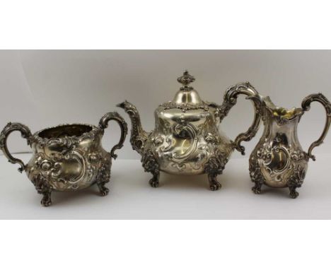 EDWARD &amp; JOHN BARNARD A VICTORIAN SILVER THREE PIECE TEA SERVICE of Rococo form, comprising; teapot, milk jug, two handle