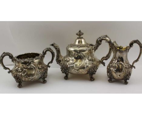 EDWARD &amp; JOHN BARNARD A VICTORIAN SILVER THREE PIECE TEA SERVICE of Rococo form, comprising; teapot, milk jug, two handle