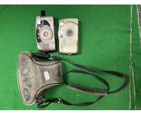 A Canon AE-1 camera (No. 2943015), a Samsung Fino 60S camera and a Kodak Advantix F600 camera