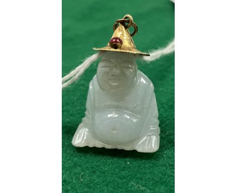 A pale jade pendant carved as a seated smiling Buddha in wide rimmed yellow metal hat set with cabouchon cut garnet, 6 g tota