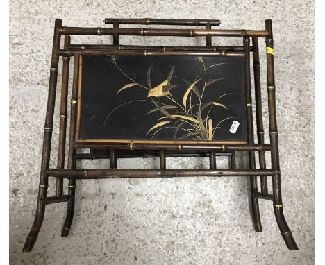 A bamboo and lacquered two section magazine rack in the Oriental taste, 48 cm wide x 23.5 cm deep x 49.5 cm high together wit