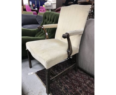 A 19th Century Chippendale style elbow chair in the 18th Century manner, with upholstered back and arms on scroll supports, o