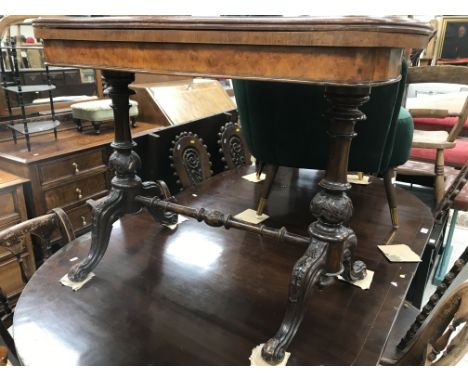 A Victorian burr walnut veneered card table, the quartered top with serpentine edge and moulded decoration, over a plain frie