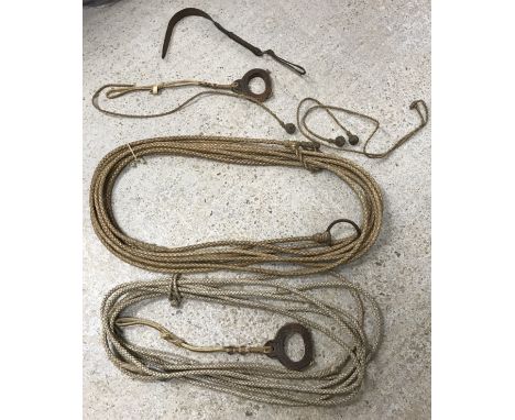 Two South American gauchos leather lassos, a set of vintage bolas and a pair of hide stirrups and leather gauchos horse whip 