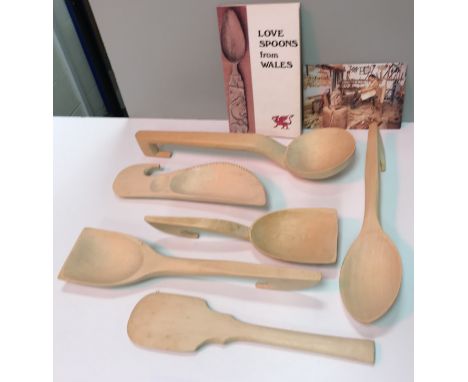 A box containing a collection of mainly sycamore Welsh spoons by Gwyndaf Breese together with "Lovespoon from Wales" publishe