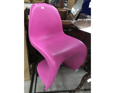 A pair of pink PVC Panton chairs by Vitra, 50 cm wide x 83 cm high together with a black PVC Cartell Ghostbuster side table/b