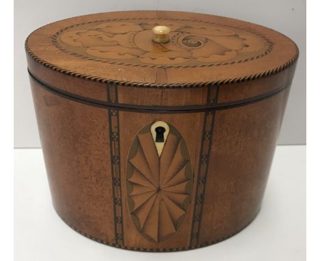 A late George III satinwood and marquetry inlaid oval tea caddy, the top with stylised shell medallion, within a barber pole 