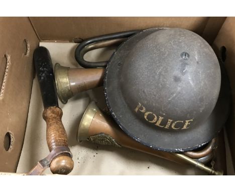 A box containing various militaria including two leather pistol holsters, an Argyle & Sutherland copper and brass bugle, a He