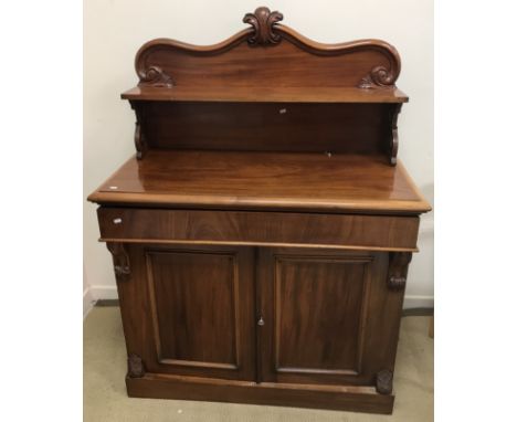 A Victorian mahogany chiffonier, the shelved superstructure with applied scrolling foliate decoration, over a single drawer a