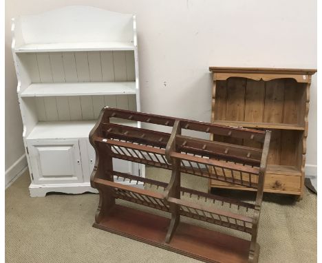 A painted pine bookcase with three graduated shelves over two fielded panel cupboard doors on bracket feet, 82 cm wide x 32 c