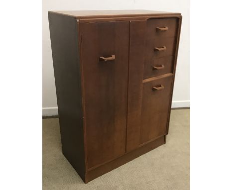 A G Plan oak tallboy chest, the plain top over a single cupboard door with hanging space and three short drawers, the upper h
