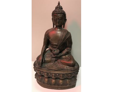 A bronze Buddha figure holding an offering bowl in its left hand raised on lotus flower base, 43.5 cm high  CONDITION REPORTS