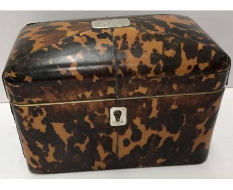 A Regency tortoiseshell veneered and pewter strung tea caddy of rectangular form, the shallow domed top with white metal plaq