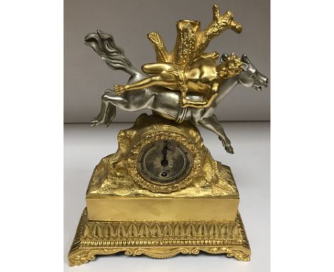 A 19th Century French gilt bronze mantel clock decorated with man strapped to the back of a silvered horse by tree stump, the