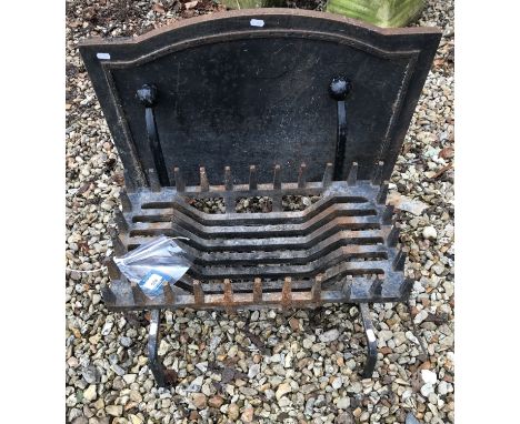 A cast iron fire back and a cast iron grate