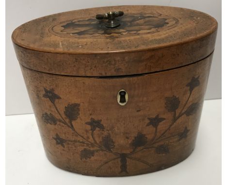 A George III satinwood and marquetry inlaid oval tea caddy, the top with flower head medallion decoration, opening to reveal 