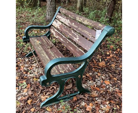 A slatted garden bench with painted cast metal ends, 123.5 cm long x 66 cm deep x 84 cm high