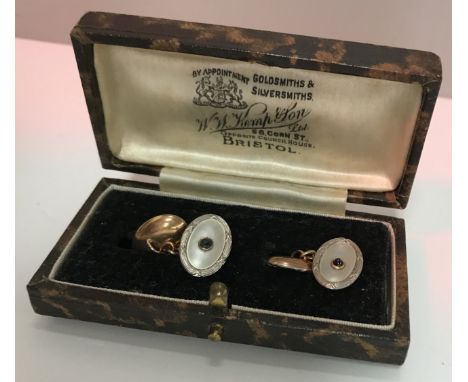 A pair of gold mounted mother of pearl and cabouchon cut sapphire cufflinks together with a composite cased set of six mother