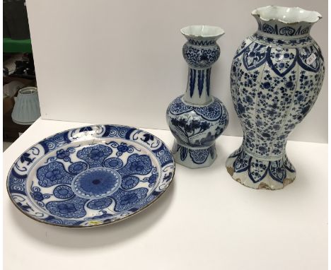 An 18th Century Dutch Delft vase of gourd form with flared rim, the main body decorated with Chinese figures in a landscape w