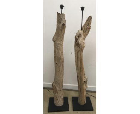 A pair of driftwood standard lamps of plain log form on ebonised block bases, each approx. 149 cm high and a modern anodised 